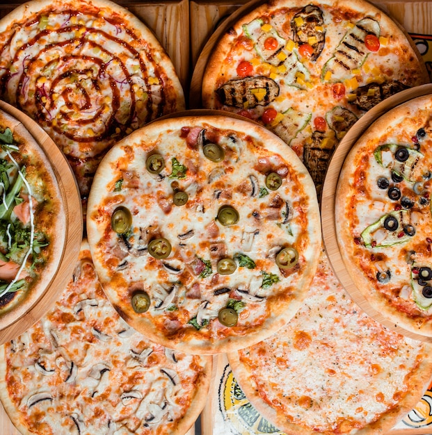 Various pizzas on the table top view