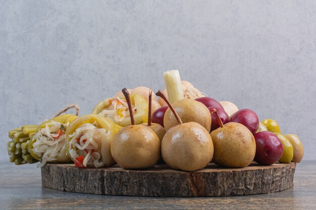 Various preserved vegetables on a board.