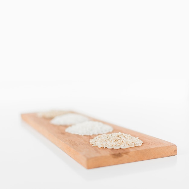 Various rice in a row on wooden tray