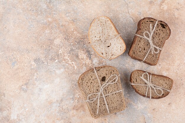 Various rye bread stacks on marble background