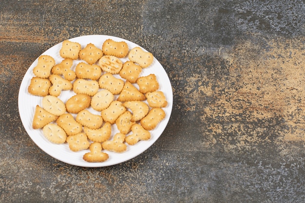 Various salted crackers on white plate. 