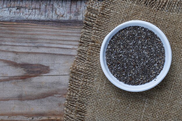 Various seeds - sesame, flax seed, flax seeds, pumpkin seed, poppy, chia in bowls on a rustic . Copy .