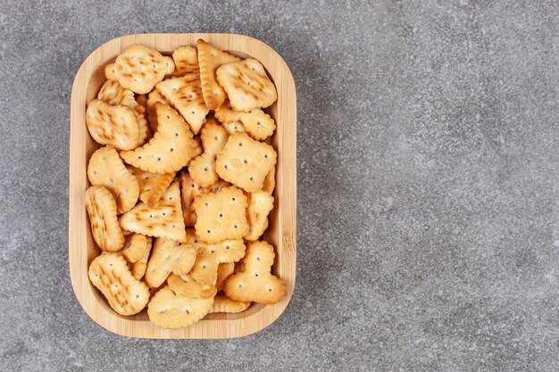 Various shaped biscuits on wooden plate