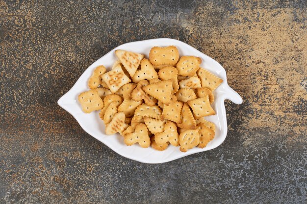 Various shaped salted crackers on leaf shaped plate. 