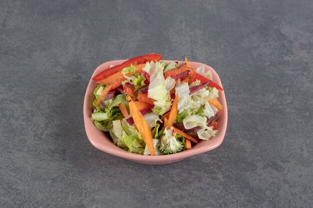 Various sliced vegetables in pink bowl. High quality photo