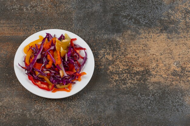 Various sliced vegetables on white plate.