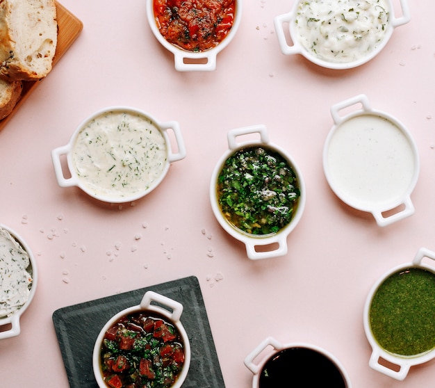 Various soups and salads on the table