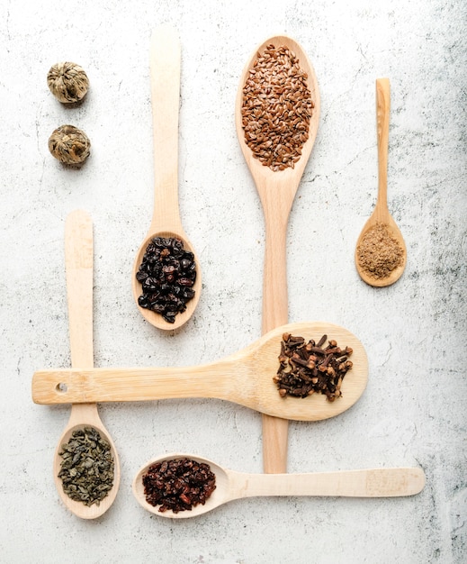 Various spoons with arrangement of seeds