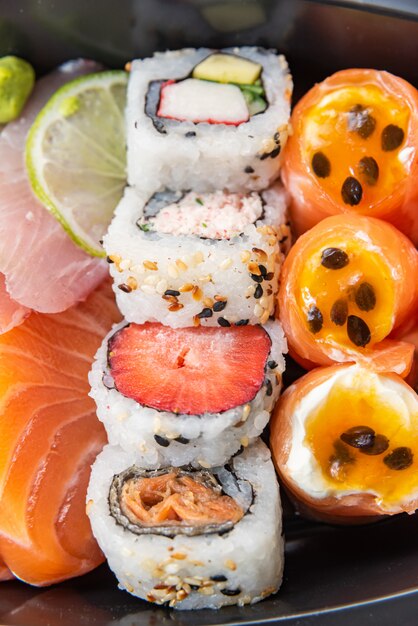 Various sushi on the plate on the table - detail