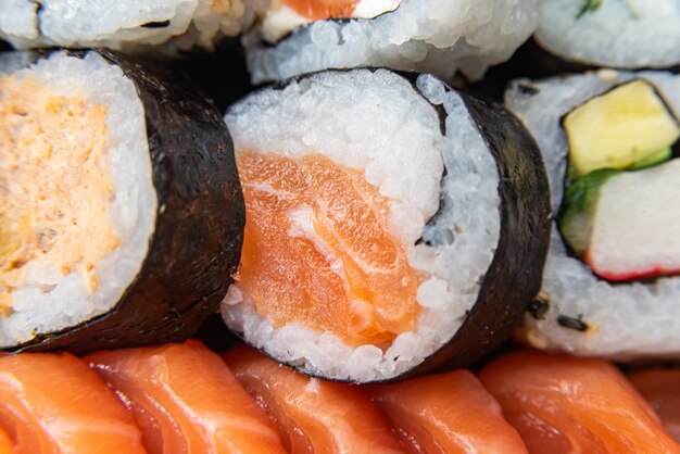 Various sushi on the plate on the table - detail