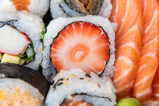 Various sushi on the plate on the table - detail