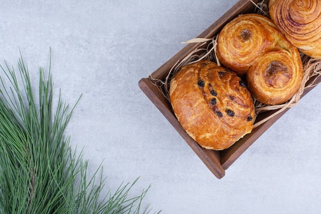 Various sweet pastries in wooden bowl.