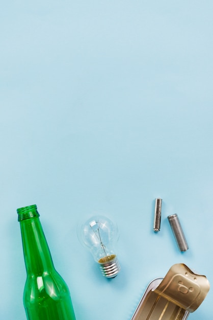 Various tips of recyclable garbage on light blue background