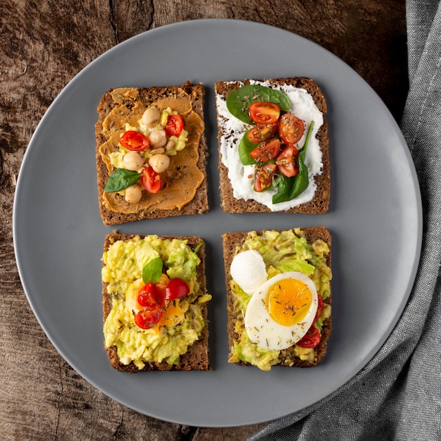 Various toasts with veggie cream flat lay