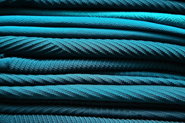 Various turquoise colored designer fabrics inside a textile store