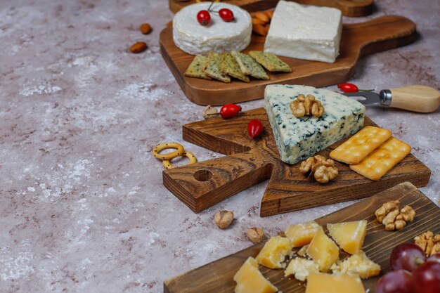 Various types of cheese on light  brown surface