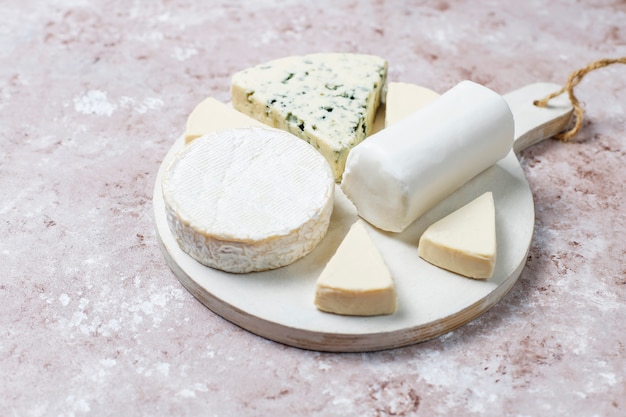 Various types of cheese on light  brown surface