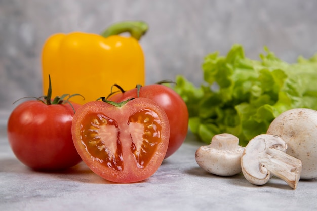 Various types of fresh healthy vegetables placed on stone