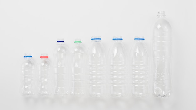 Various types of plastic bottles on grey background