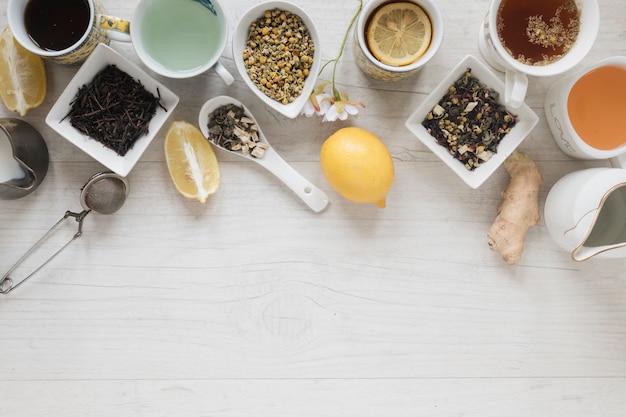 Free photo various types of tea with herbs and dry leaves on wooden table