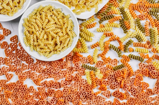 Various uncooked pasta on white