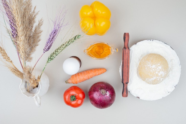 Free photo various vegetables with egg and oil on white.