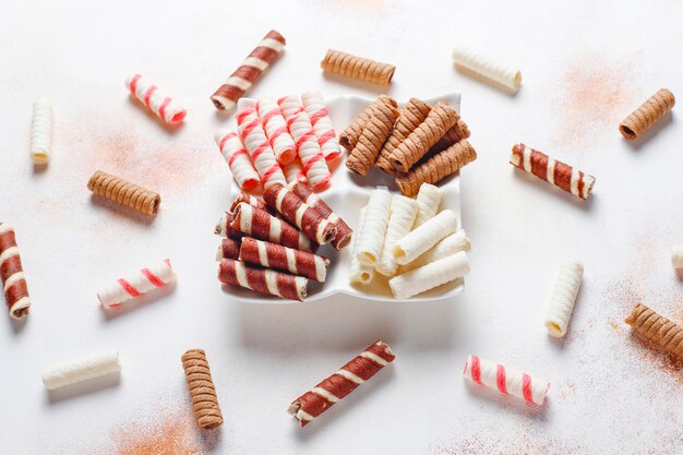 Various waffle rolls in ceramic plates,top view.