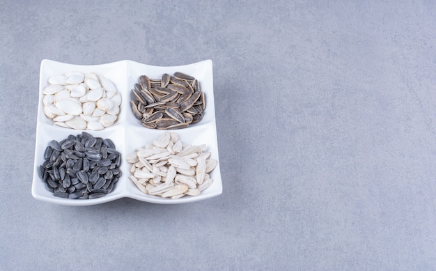 Variously seeds in a bowl on the marble surface