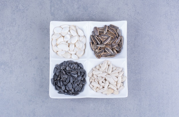 Free photo variously seeds in a bowl on marble.