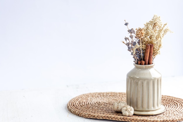 Free photo vase with dried flowers and cinnamon sticks isolated on white background