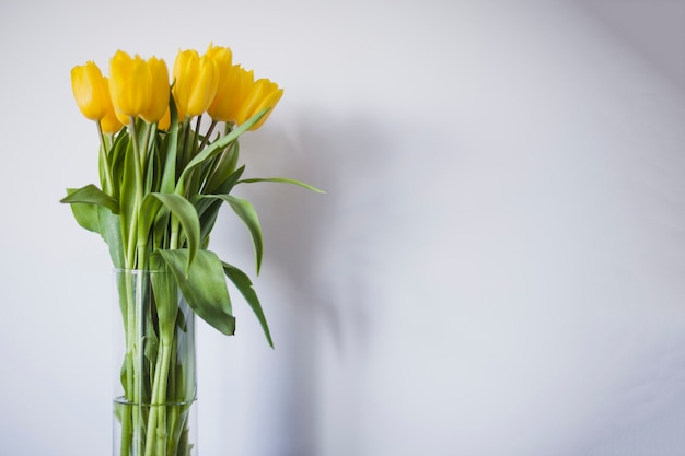 Vase with yellow tulips