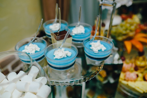 Vases with a blue substance and marshmallows