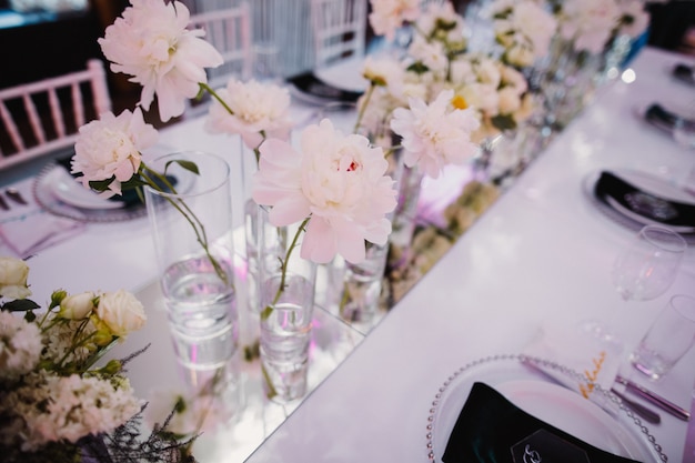 Free photo vases with peonies on table