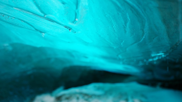 Free photo vatnajokull glacier blue ice blocks inside crevasse in iceland, beautiful polar scenery with icy frozen rocks. transparent iceberg in ice cave path with covered frost wintry snow. handheld shot.