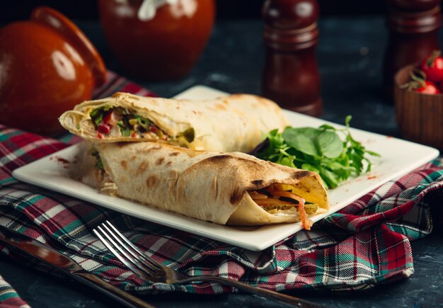 vegan burrito with sauce and salad