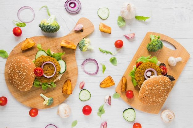 Vegan food on cutting boards on white wooden table