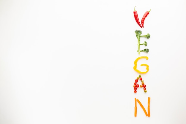 Free photo vegan lettering made out of vegetables with copy space