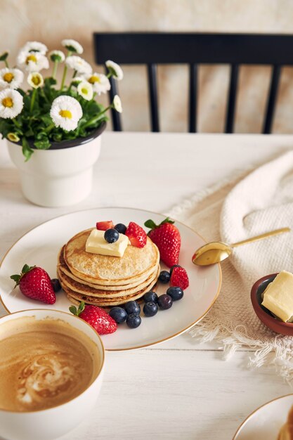 vegan tofu pancakes on a white plate with fruits