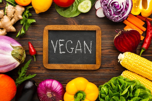 Vegetable arrangement with vegan lettering on chalkboard 