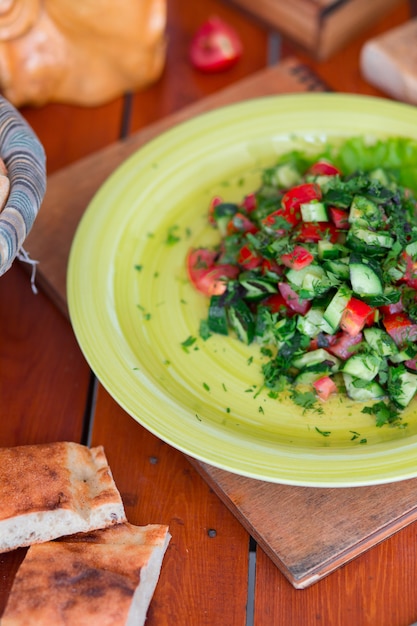 Free photo vegetable green salad, choban salati in green plate.