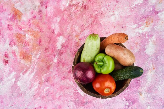 Free photo vegetable mix in a wooden bucket.