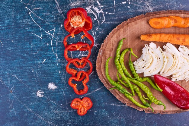 Vegetable mix on a wooden platter, top view. 