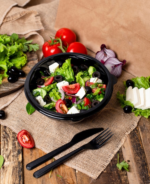 Vegetable Roka Salad with feta white cheese, green salad, tomatoes and olives 