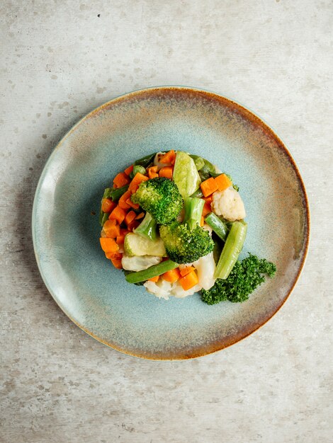 Vegetable salad topped with broccoli