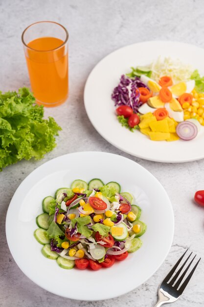 Vegetable salad with boiled eggs in a white dish.