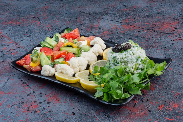 Vegetable salad with chopped tomato, cucumber and herbs. 