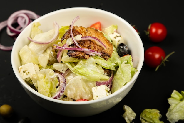 Vegetable salad with fried chicken close-up view