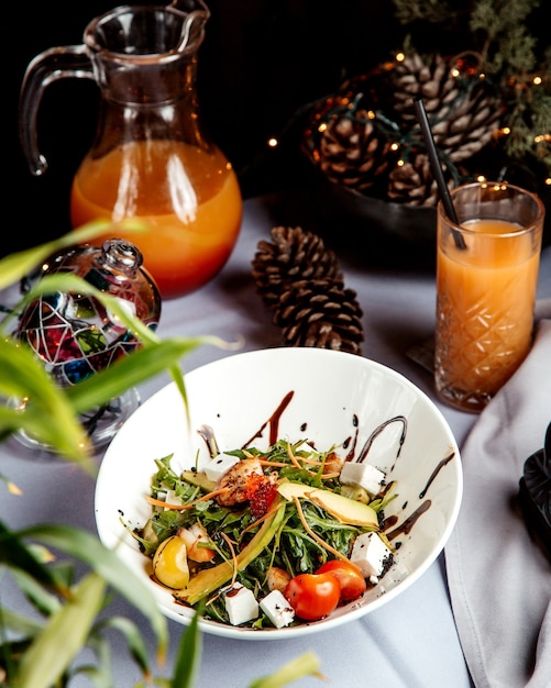 Vegetable salad with herbs and glass of juice