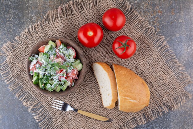 Vegetable salad with herbs and red tomatoes in a plate