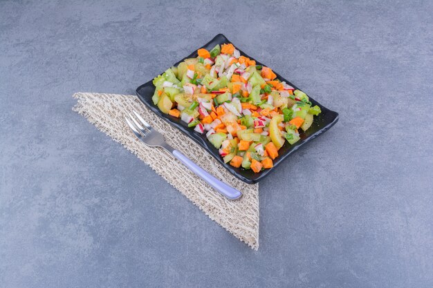 Vegetable salad with seasonal foods in a ceramic dish